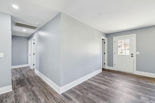 foyer entrance featuring baseboards, visible vents, and wood finished floors