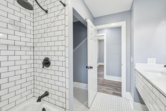 full bath with baseboards, a sink, shower / bathtub combination, and tile patterned floors