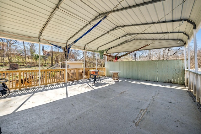 view of patio / terrace with fence and a detached carport