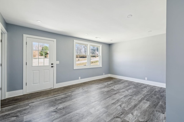 entrance foyer featuring baseboards and dark wood-type flooring