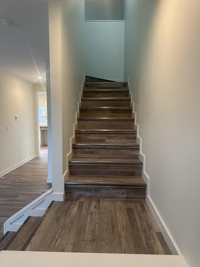 stairs with baseboards and wood finished floors