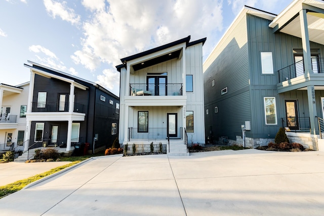 view of front of property with board and batten siding and a balcony