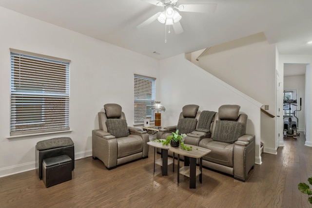 living room featuring stairs, ceiling fan, baseboards, and wood finished floors