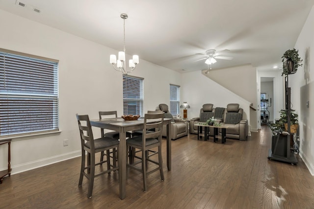 dining room featuring dark wood-style floors, visible vents, and baseboards