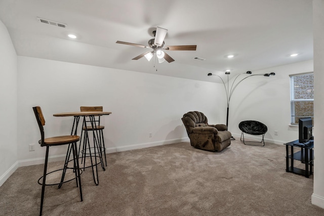 living area with carpet floors, baseboards, and visible vents