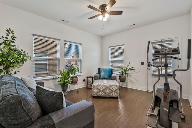 sitting room featuring baseboards, ceiling fan, visible vents, and wood finished floors