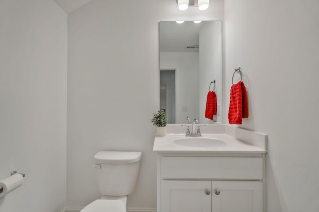 bathroom featuring toilet, baseboards, visible vents, and vanity