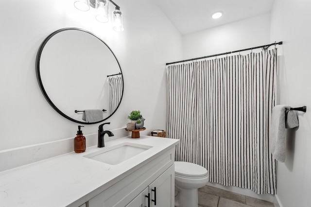 bathroom with tile patterned flooring, a shower with curtain, vanity, and toilet