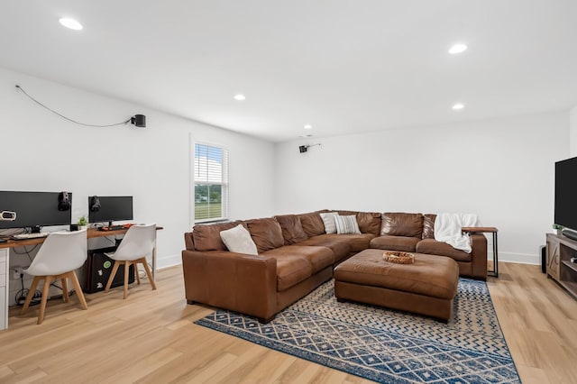 living area featuring baseboards, light wood-style flooring, and recessed lighting