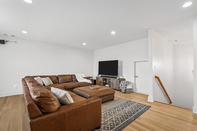 living area with light wood-type flooring, visible vents, and recessed lighting