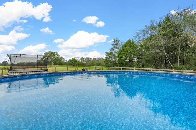 view of swimming pool featuring fence and a fenced in pool