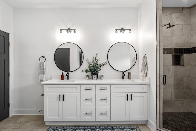 full bathroom featuring a sink, a shower stall, and double vanity