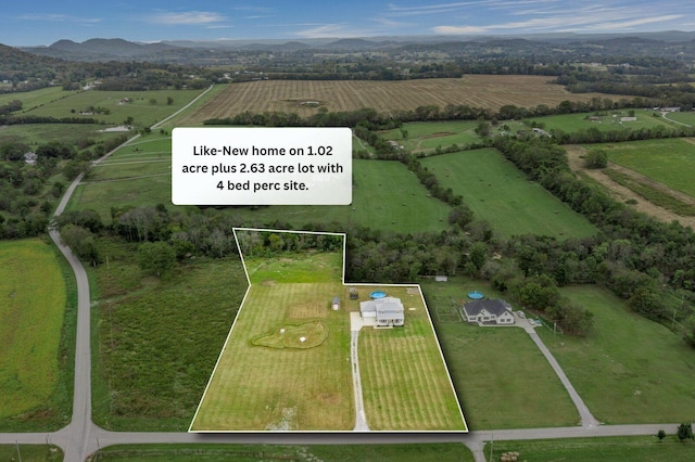 birds eye view of property with a rural view and a mountain view