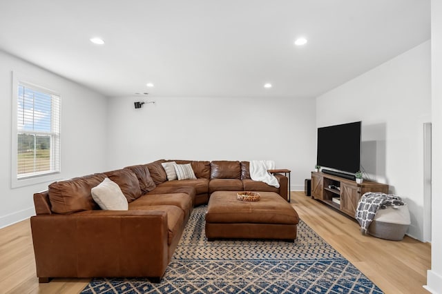 living room with recessed lighting, light wood-style flooring, and baseboards