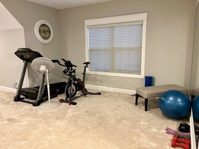 workout area featuring carpet flooring and baseboards