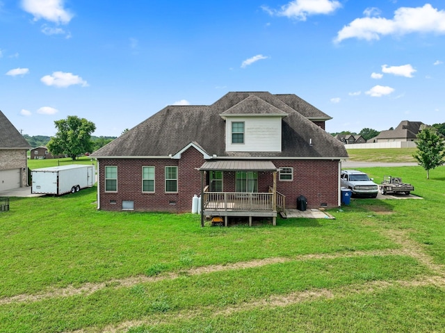 back of property featuring crawl space, roof with shingles, a lawn, and brick siding