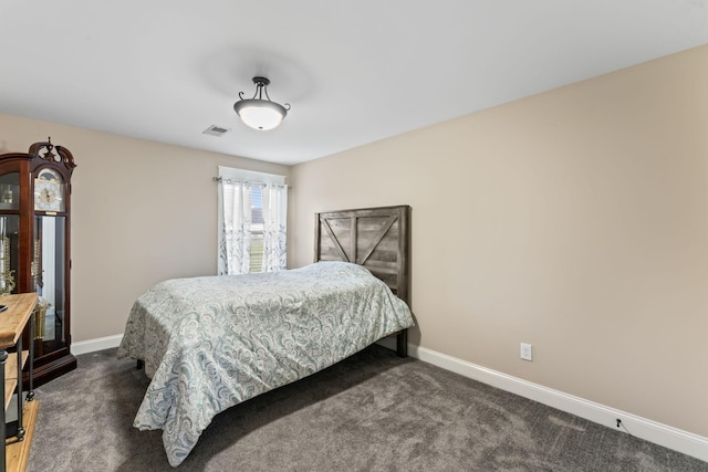 bedroom featuring dark colored carpet, visible vents, and baseboards