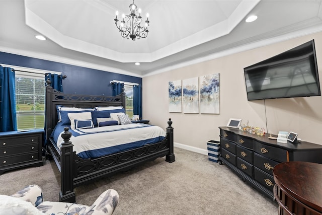 bedroom with carpet floors, multiple windows, and a tray ceiling