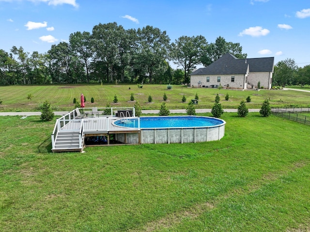 outdoor pool with a deck and a lawn