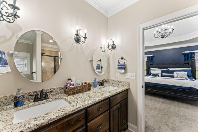 bathroom featuring ensuite bathroom, ornamental molding, a sink, and an enclosed shower