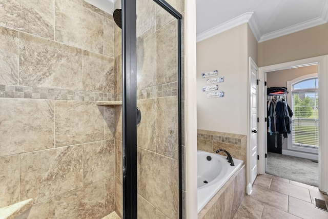 bathroom with ornamental molding, tile patterned floors, a walk in closet, a shower stall, and a bath