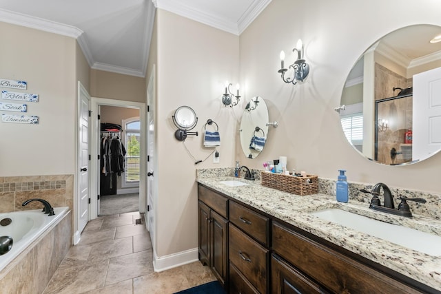 bathroom with tiled tub, ornamental molding, a walk in closet, and a sink