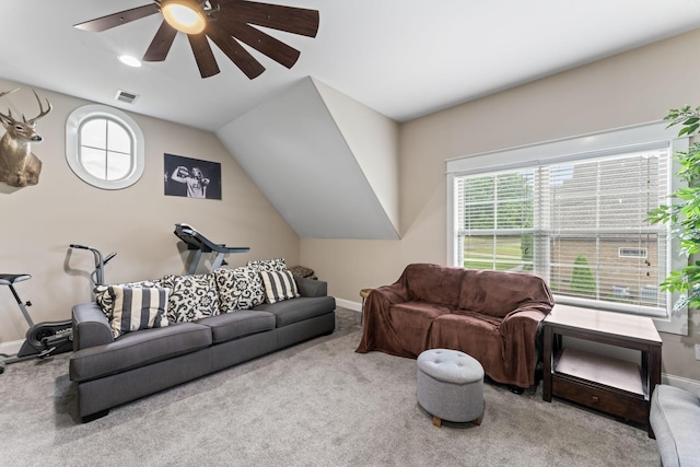 carpeted living area featuring lofted ceiling, a ceiling fan, visible vents, and baseboards