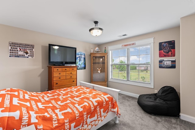 bedroom featuring baseboards, visible vents, and carpet flooring