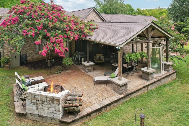 view of patio / terrace featuring an outdoor living space with a fire pit