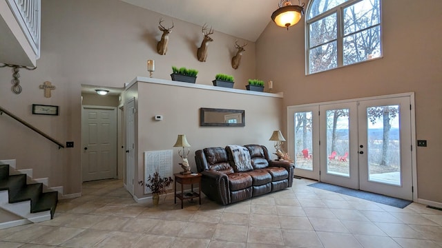 living room with light tile patterned floors, plenty of natural light, stairs, and visible vents