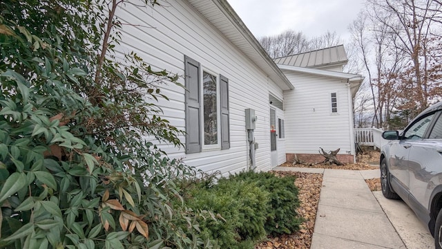 view of side of property with a standing seam roof and metal roof