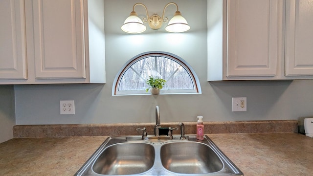 kitchen with white cabinetry and a sink