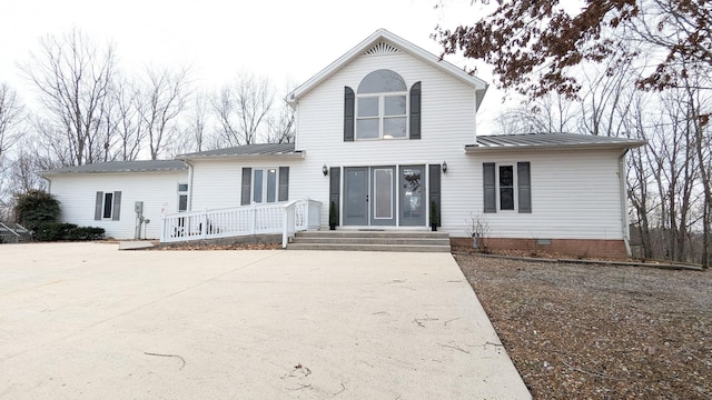 traditional-style home featuring crawl space, metal roof, and a standing seam roof