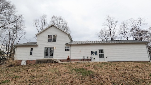 rear view of house featuring metal roof and french doors