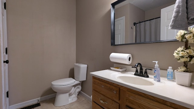 bathroom featuring visible vents, baseboards, toilet, tile patterned flooring, and vanity