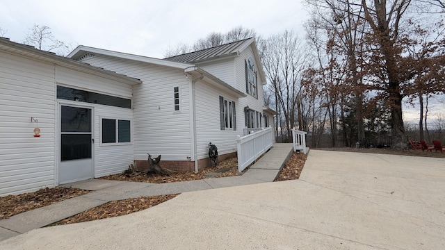 view of side of property featuring metal roof