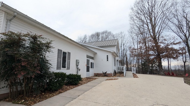 view of side of home with metal roof