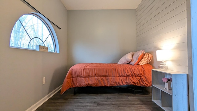 bedroom featuring wood finished floors and baseboards