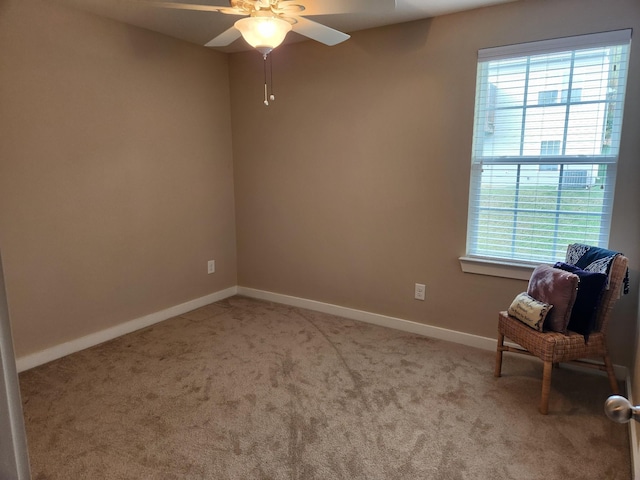 unfurnished room with carpet, a ceiling fan, and baseboards