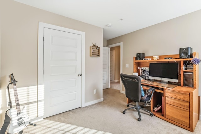 carpeted office featuring baseboards