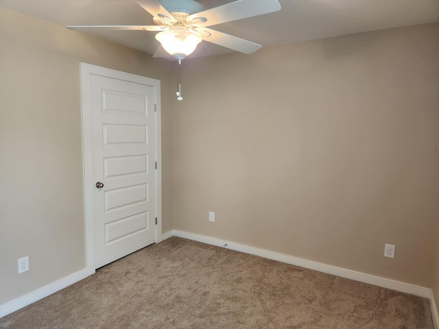 empty room with ceiling fan, carpet flooring, and baseboards