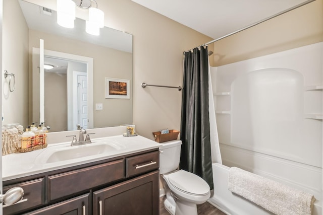 bathroom featuring shower / tub combo, visible vents, vanity, and toilet