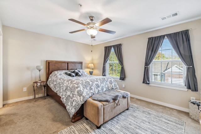 carpeted bedroom featuring visible vents, ceiling fan, and baseboards