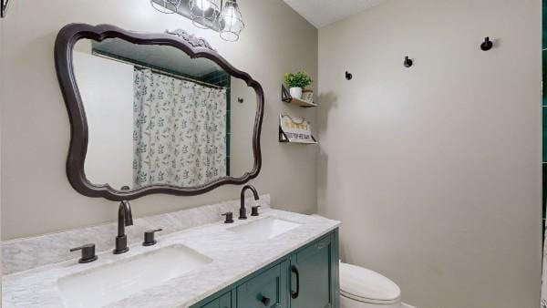 bathroom with toilet, double vanity, a sink, and a shower with shower curtain