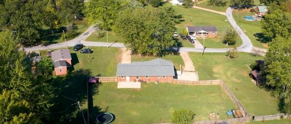 birds eye view of property with a rural view