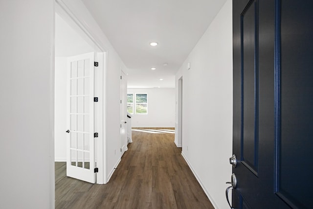 hall with recessed lighting, dark wood-style flooring, and baseboards