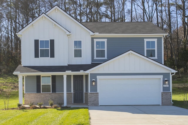 view of front of property with concrete driveway, brick siding, board and batten siding, and a front yard