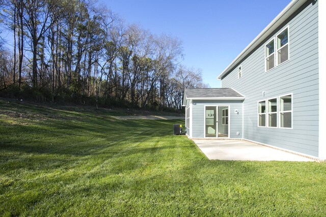 view of yard featuring central AC unit and a patio area