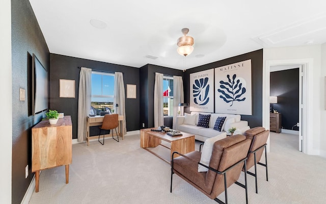 living area featuring light colored carpet, visible vents, and baseboards