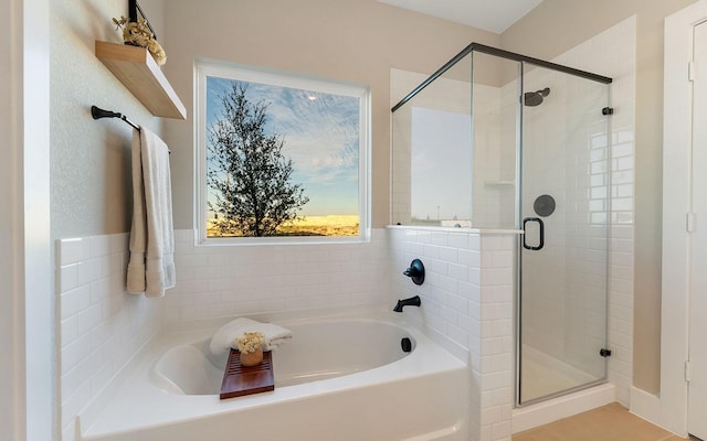 full bath featuring a shower stall and a bath